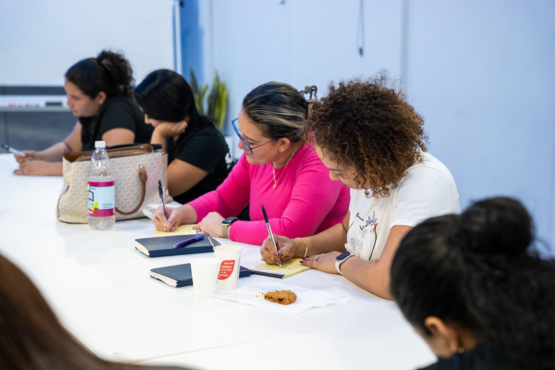 Participants taking notes during a session